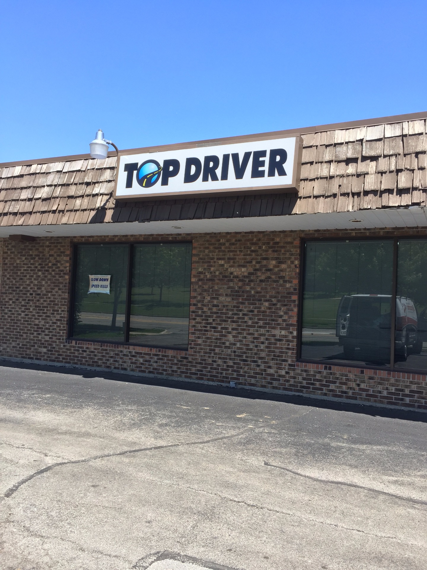 top driver storefront and parking lot