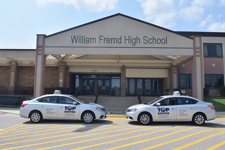 Outside of William Fremd High School with Top Driver cars.